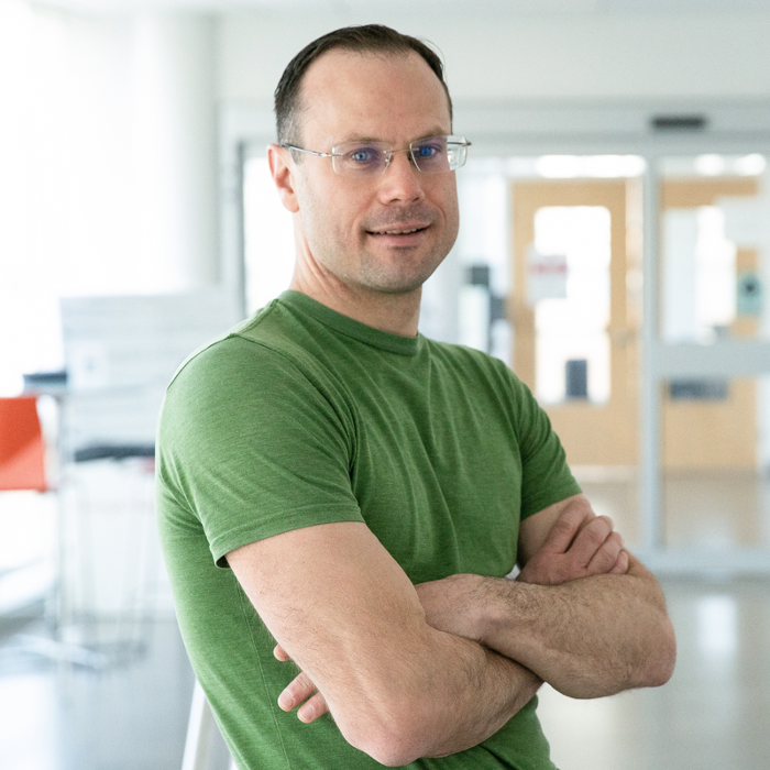 a white man wearing glasses and a green t-shirt